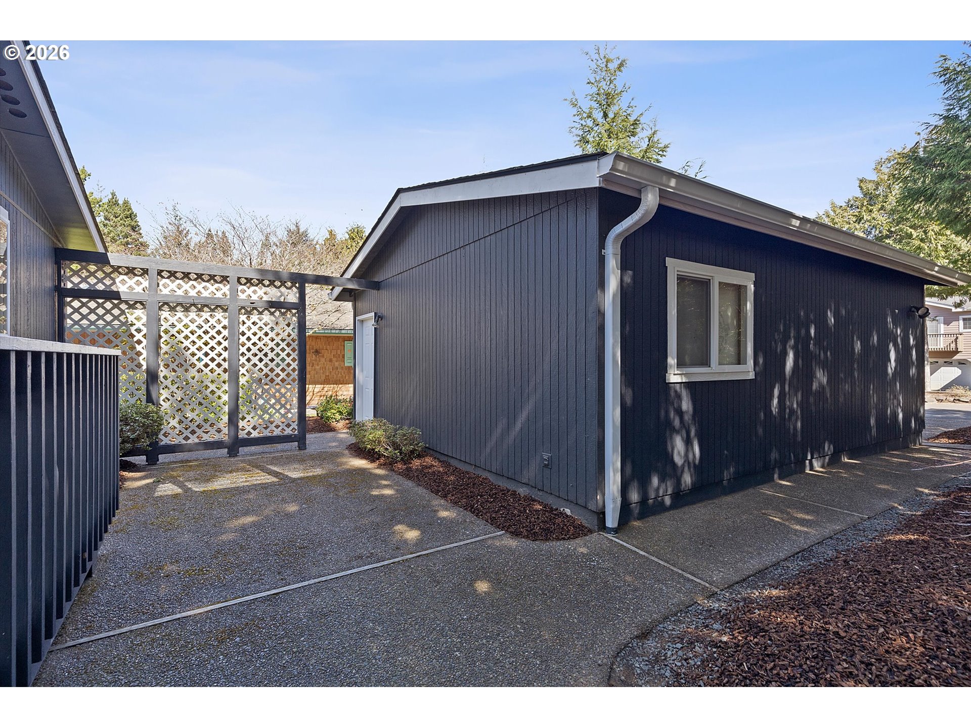 395 Seagrove Loop Lincoln City, OR 97367 - Photo 36 of 46 a backyard of a house with table and chairs