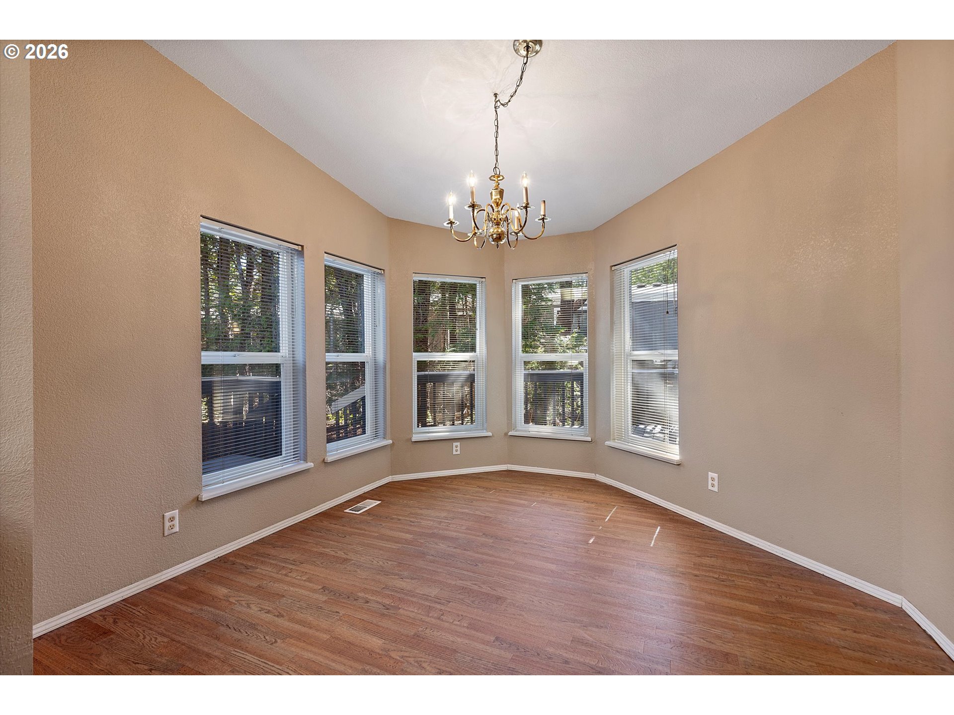 395 Seagrove Loop Lincoln City, OR 97367 - Photo 5 of 46 a view of an empty room with wooden floor and windows