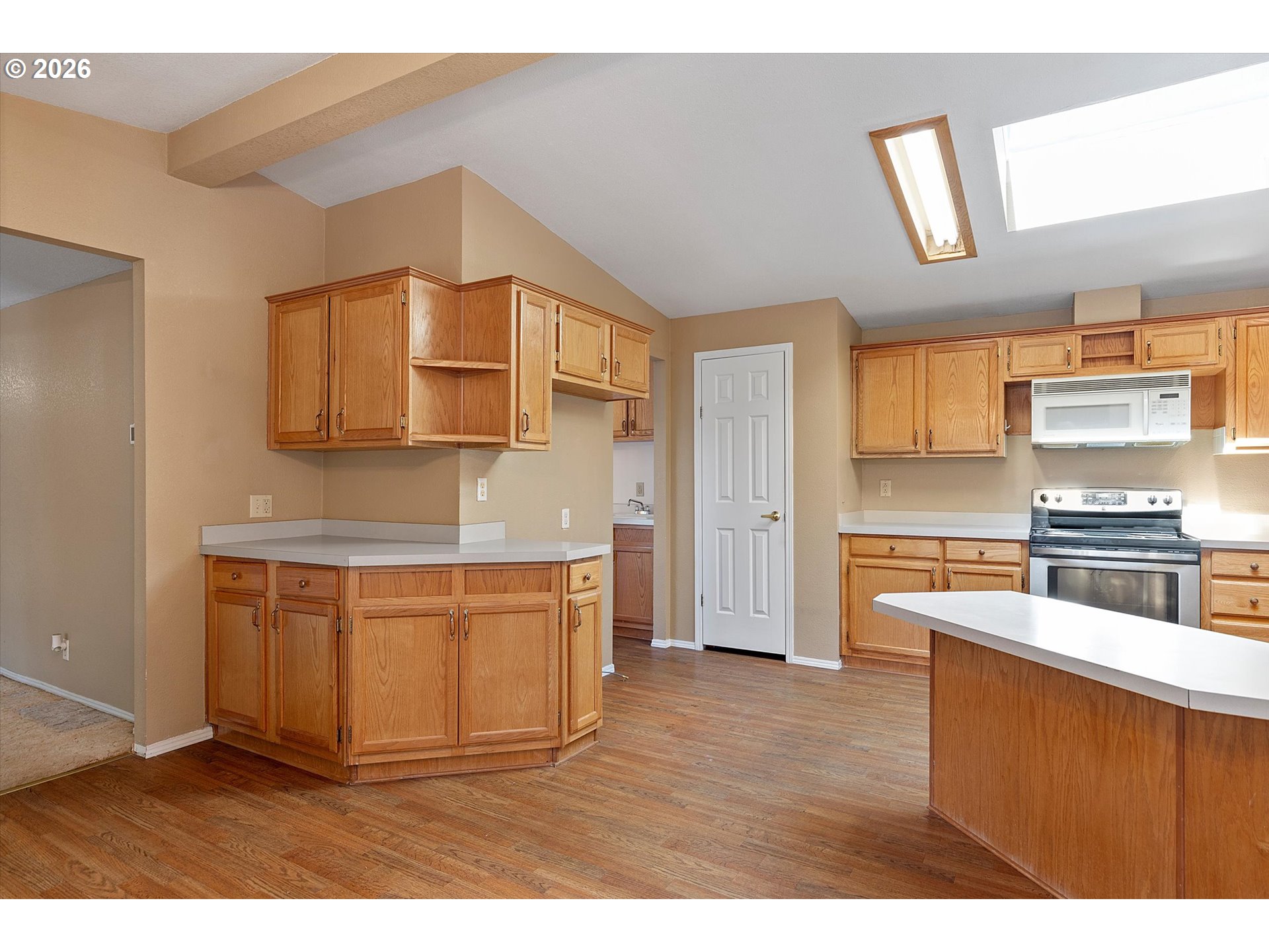 395 Seagrove Loop Lincoln City, OR 97367 - Photo 6 of 46 a kitchen with stainless steel appliances granite countertop a stove a sink and a refrigerator