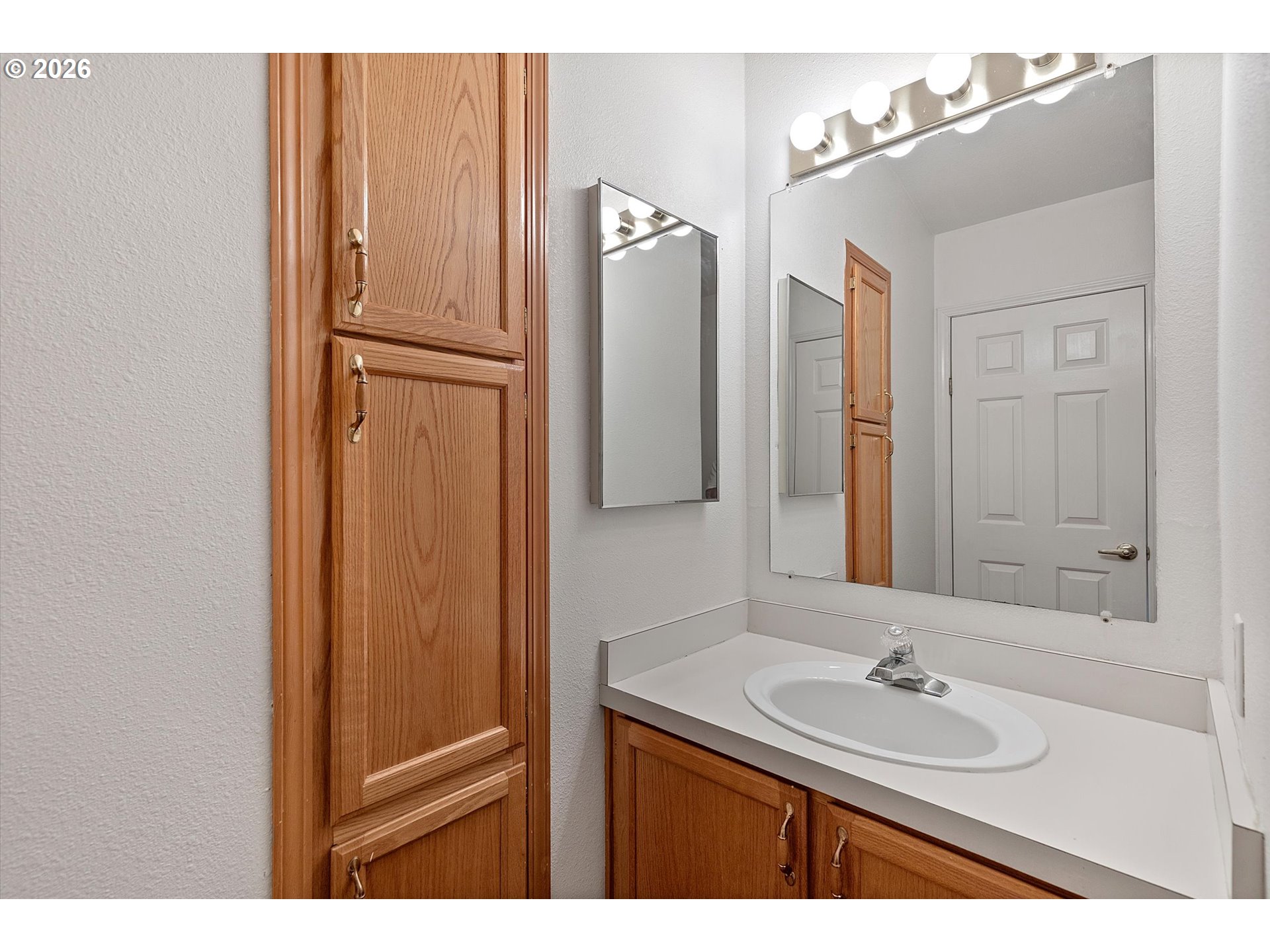 395 Seagrove Loop Lincoln City, OR 97367 - Photo 9 of 46 a bathroom with a sink and mirror
