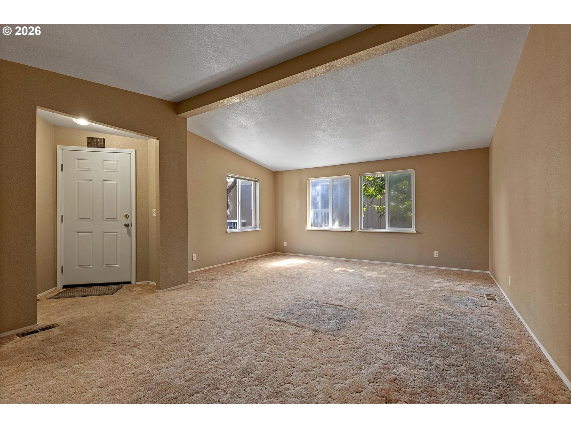 395 Seagrove Loop Lincoln City, OR 97367 - Photo 10 of 46 a view of empty room with windows