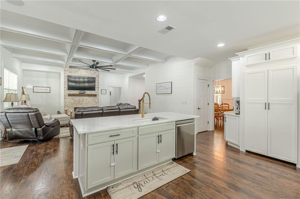 21 Lovell Road Temple, GA 30179 - Photo 18 of 77 a large white kitchen with a lot of counter space and wooden floor