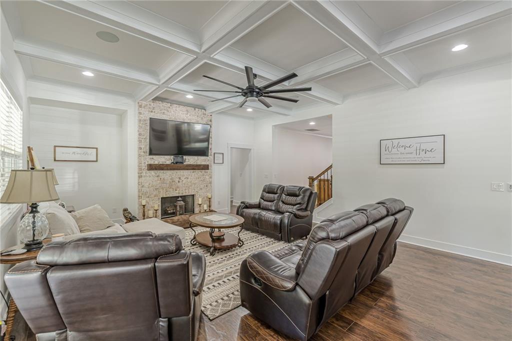 21 Lovell Road Temple, GA 30179 - Photo 32 of 77 a living room with furniture a fireplace and a ceiling fan