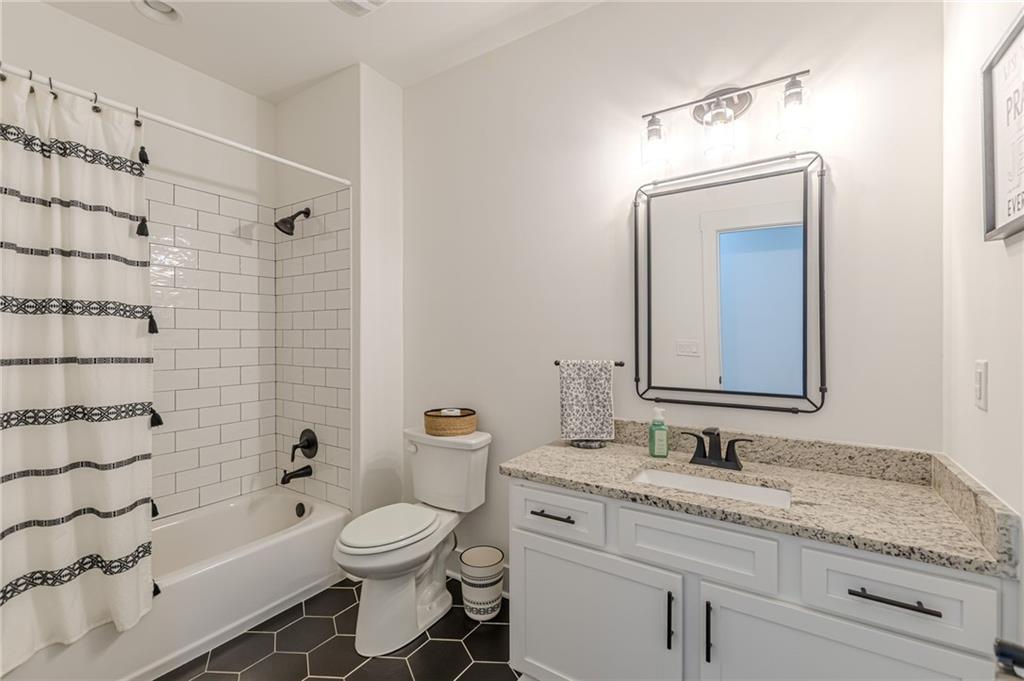 21 Lovell Road Temple, GA 30179 - Photo 42 of 77 a bathroom with a granite countertop sink toilet a shower and a mirror