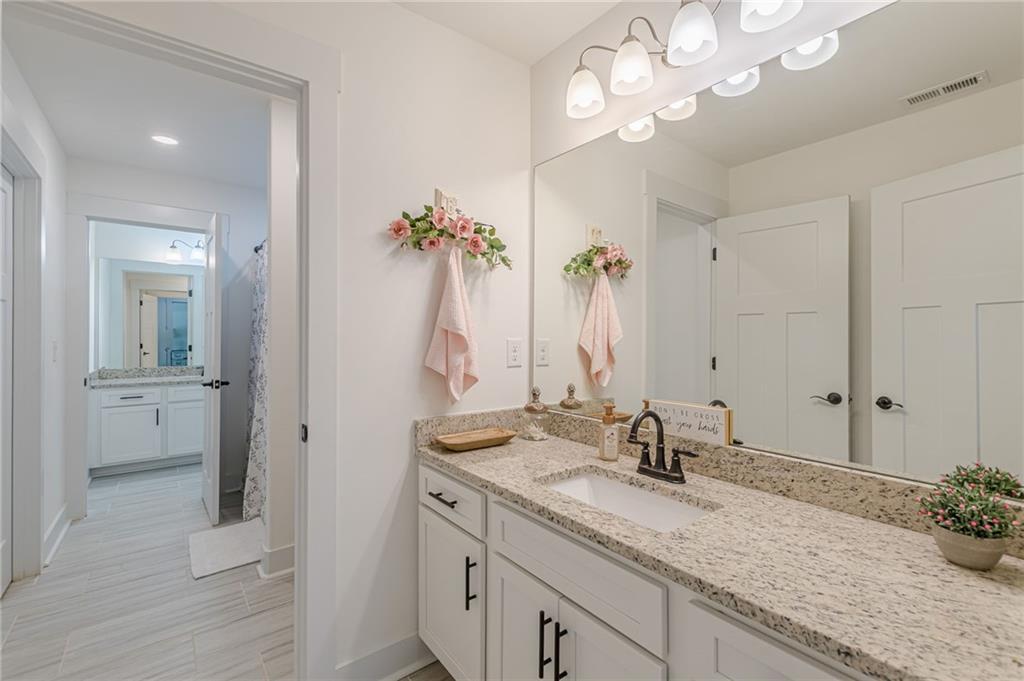 21 Lovell Road Temple, GA 30179 - Photo 50 of 77 a bathroom with a granite countertop sink and a mirror