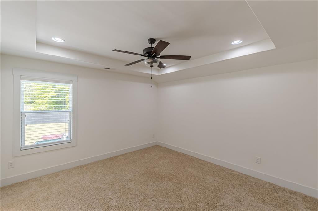 21 Lovell Road Temple, GA 30179 - Photo 52 of 77 an empty room with a window and a ceiling fan