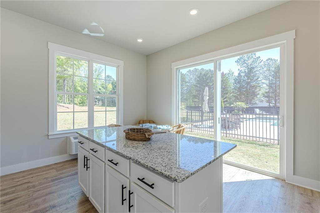 21 Lovell Road Temple, GA 30179 - Photo 63 of 77 a kitchen with granite countertop a sink and a wooden floor