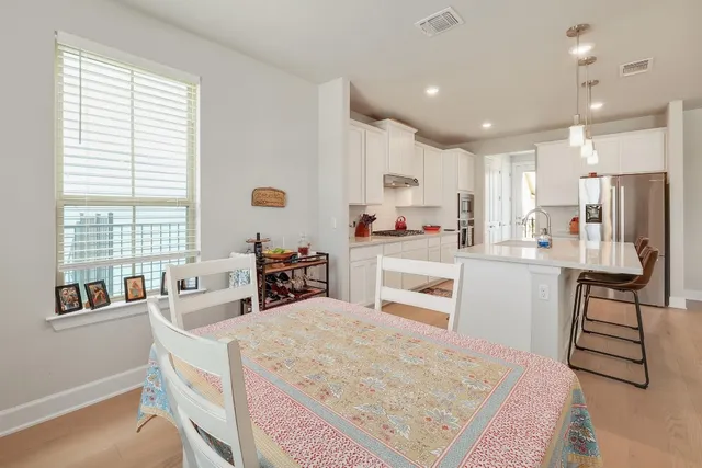 a kitchen with a sink a counter top space stainless steel appliances and cabinets
