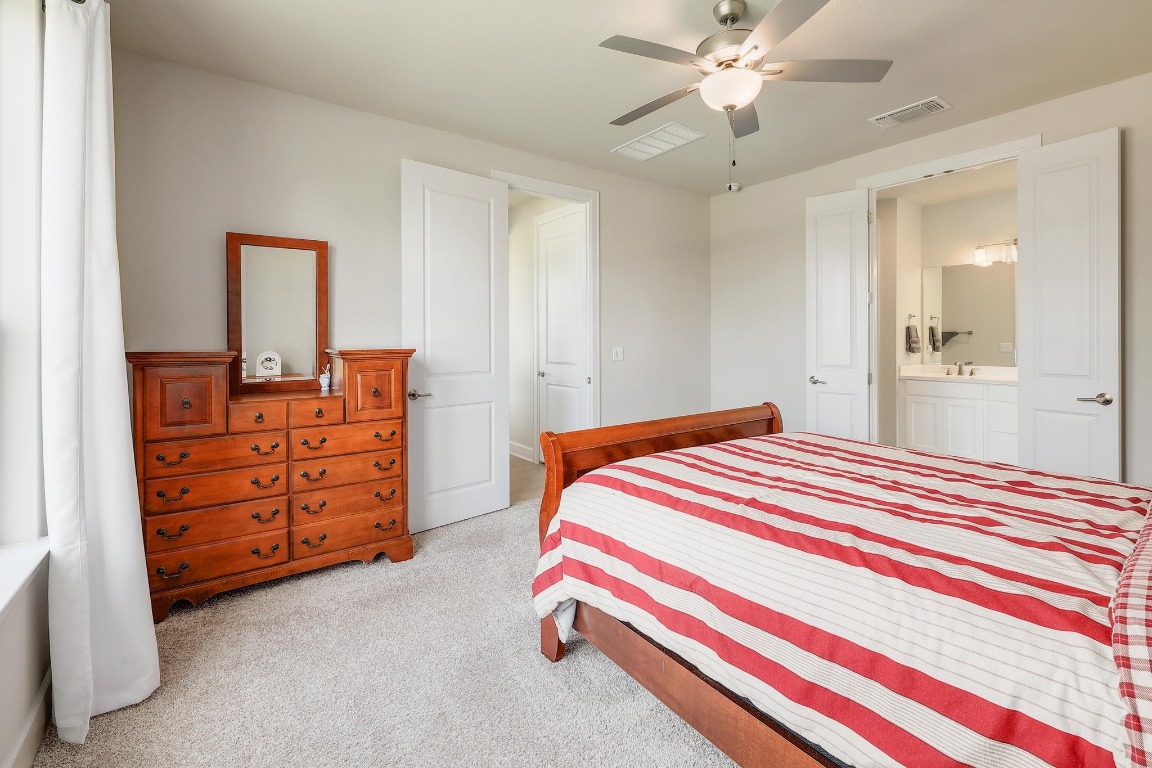 8312 Corrigan Pass Austin, TX 78744 - Photo 15 of 27 a bedroom with a bed and dresser