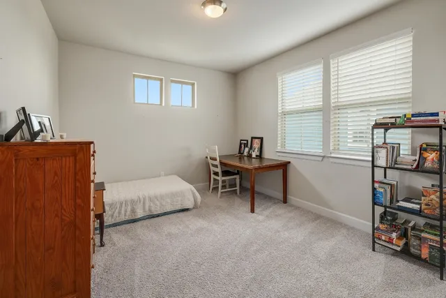 a bedroom with furniture and a window