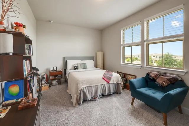 a bedroom with bed and a window