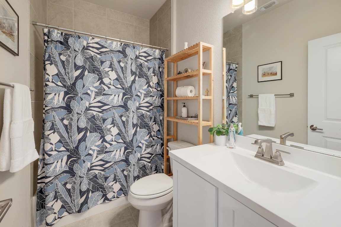 8312 Corrigan Pass Austin, TX 78744 - Photo 22 of 27 a bathroom with a sink toilet and shower