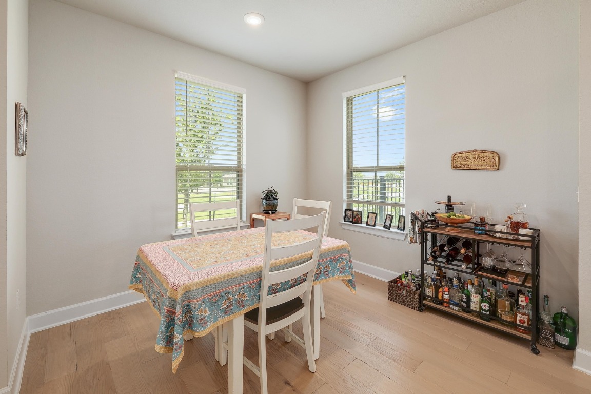8312 Corrigan Pass Austin, TX 78744 - Photo 9 of 27 a bedroom with a bed a table and a dresser next to a window
