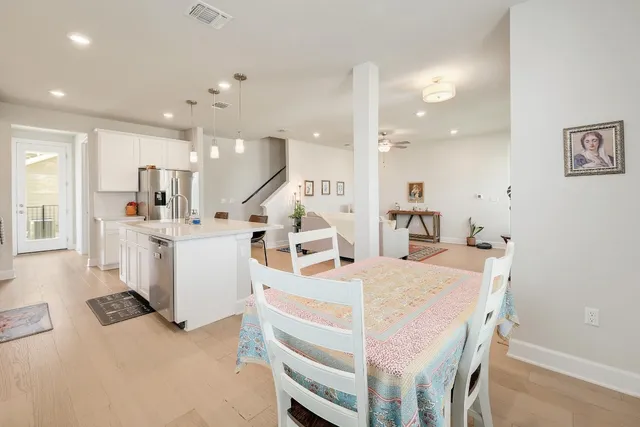 a large white kitchen with a table and chairs