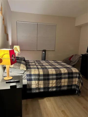 a bedroom with a bed and dresser