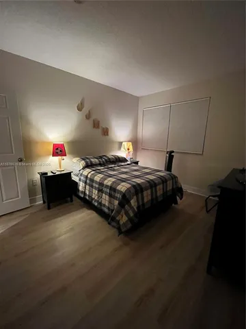 a bedroom with a bed and lamp