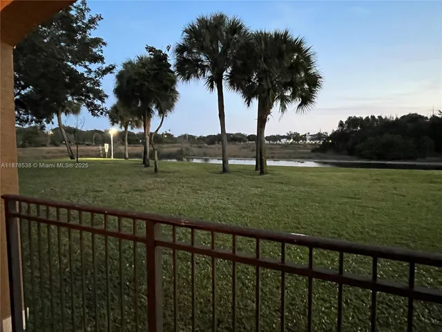 a living room with dining room and wooden floor