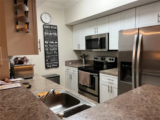 a kitchen with a stove and a microwave