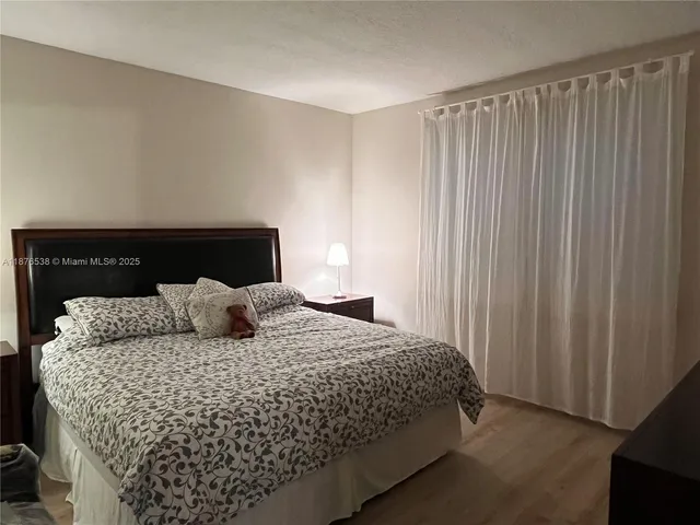 a bedroom with a bed and a lamp