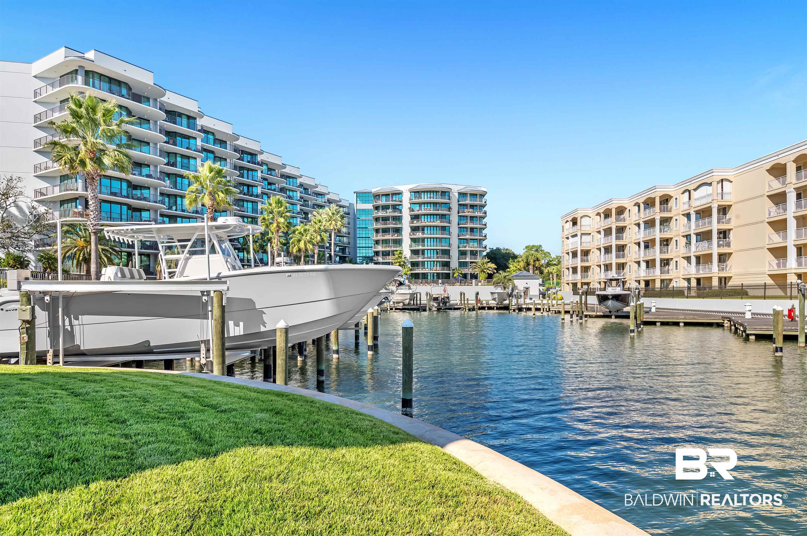 27582 Canal Road, Unit 2507 Orange Beach, AL 36561 - Photo 74 of 75 Dock area featuring a water view, a lawn, and boat lift