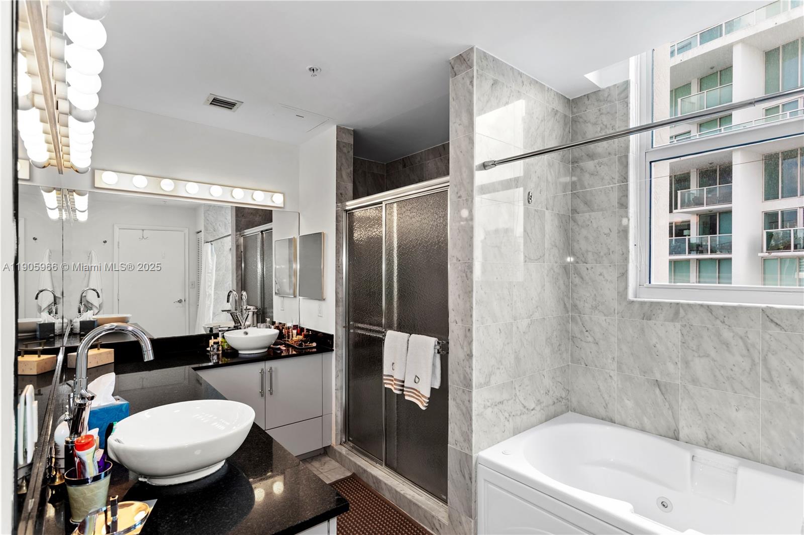 31 Southeast 5th Street, Unit 4018 Miami, FL 33131 - Photo 12 of 23 a bathroom with a sink toilet and shower