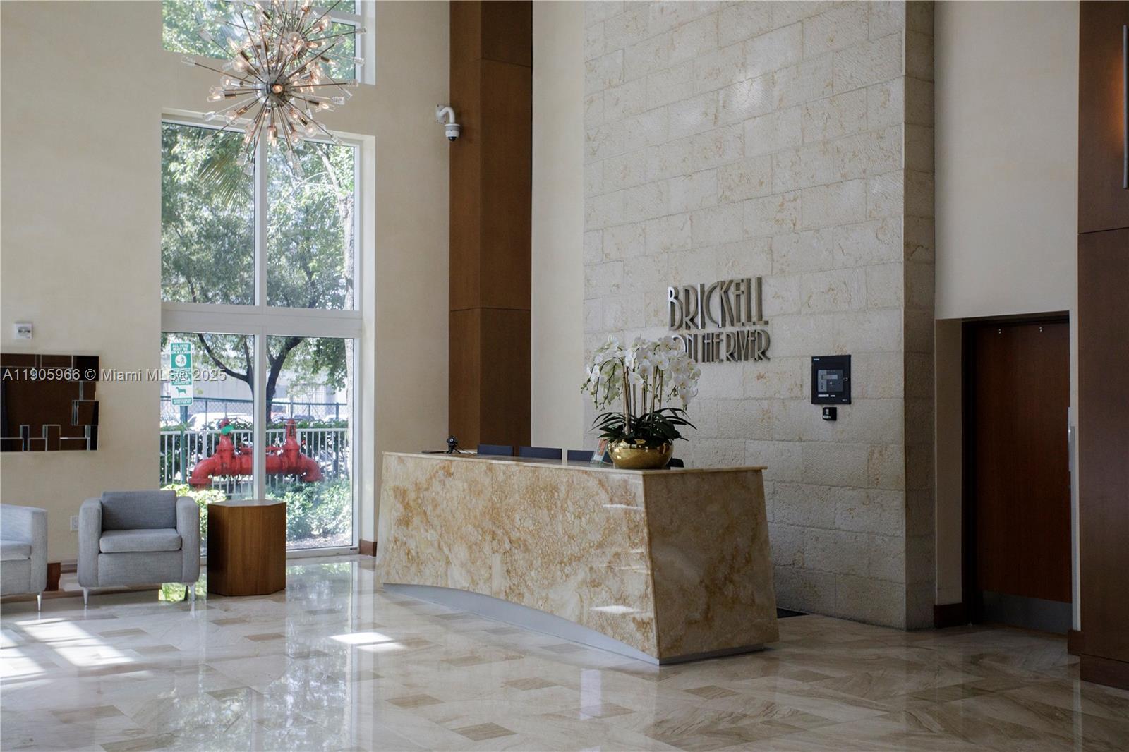 31 Southeast 5th Street, Unit 4018 Miami, FL 33131 - Photo 19 of 23 a living room with furniture and a chandelier