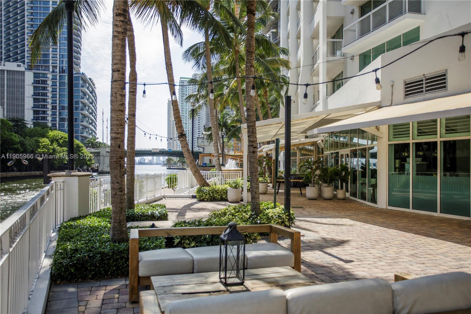 31 Southeast 5th Street, Unit 4018 Miami, FL 33131 - Photo 22 of 23 a patio with a table and chairs and potted plants