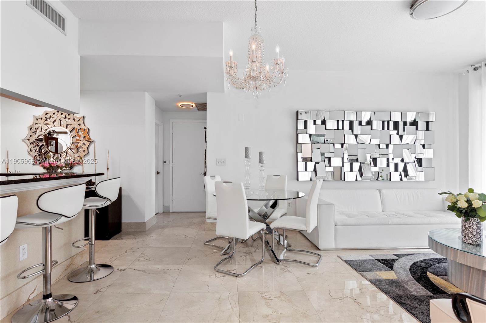 31 Southeast 5th Street, Unit 4018 Miami, FL 33131 - Photo 6 of 23 a living room with furniture and a chandelier