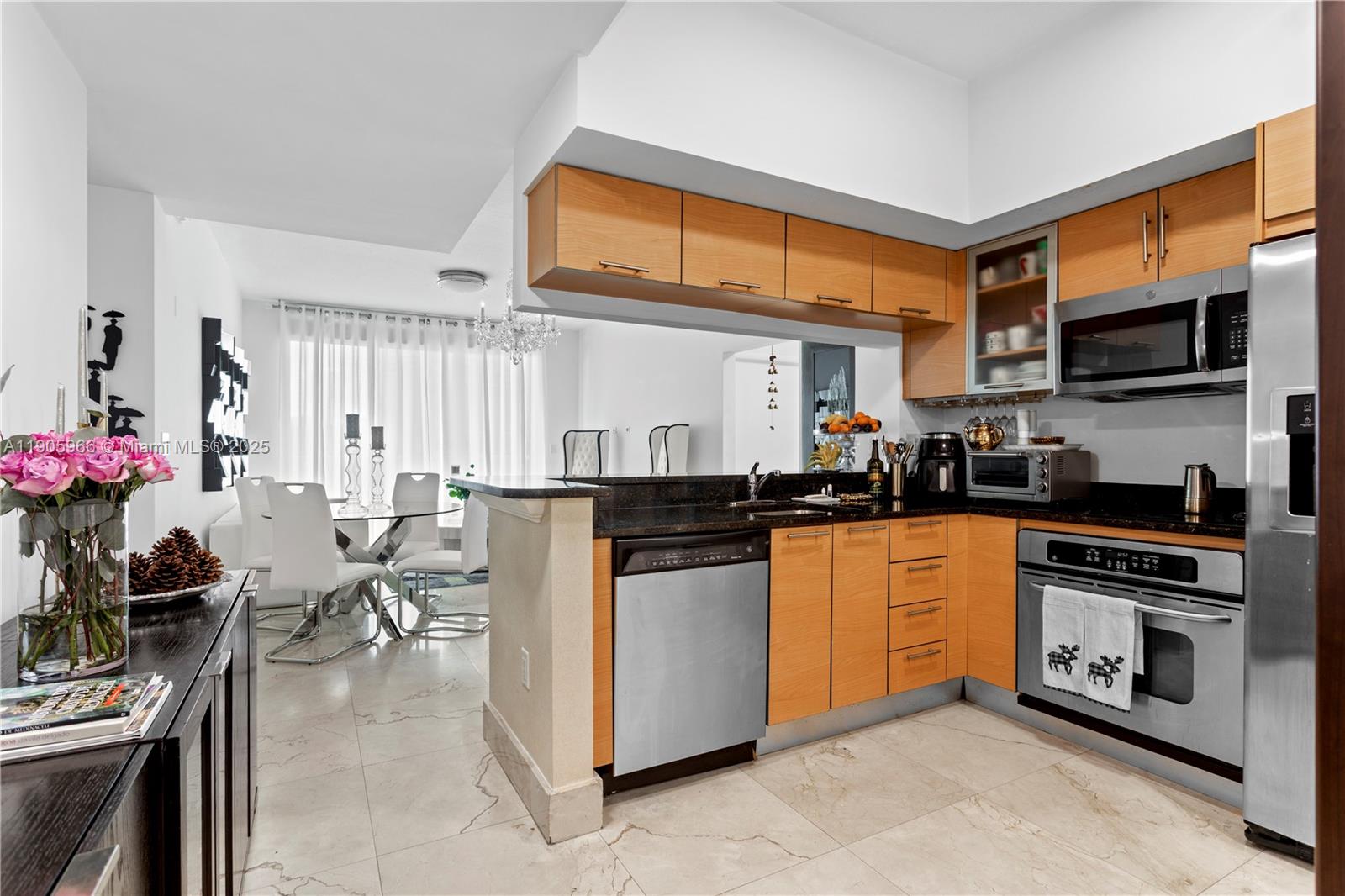 31 Southeast 5th Street, Unit 4018 Miami, FL 33131 - Photo 8 of 23 a kitchen with stainless steel appliances granite countertop a stove top oven a sink dishwasher and cabinets with wooden floor