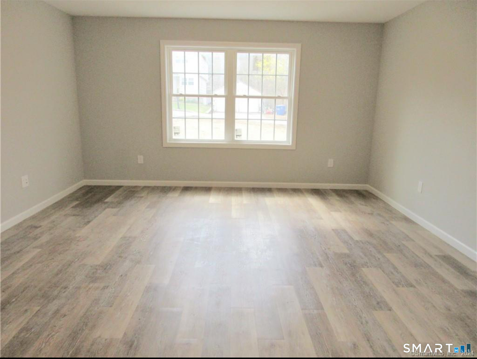 249 South Canterbury Road Canterbury, CT 06331 - Photo 15 of 20 an empty room with wooden floor and windows