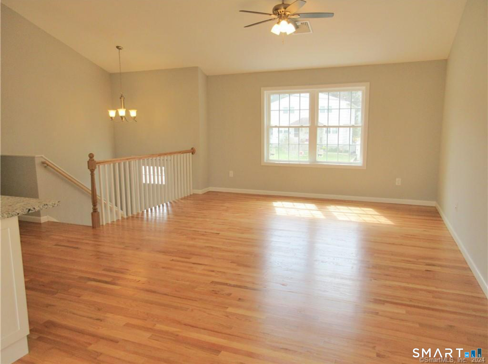 249 South Canterbury Road Canterbury, CT 06331 - Photo 3 of 20 a view of an empty room with wooden floor and a window