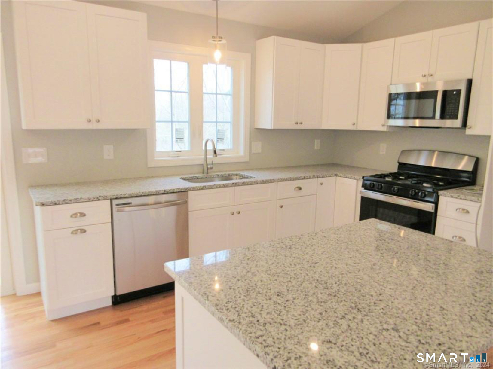 249 South Canterbury Road Canterbury, CT 06331 - Photo 8 of 20 a kitchen with granite countertop a sink a stove and cabinets