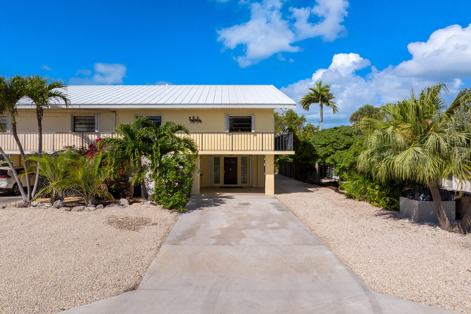 a front view of a house with a yard and a garage