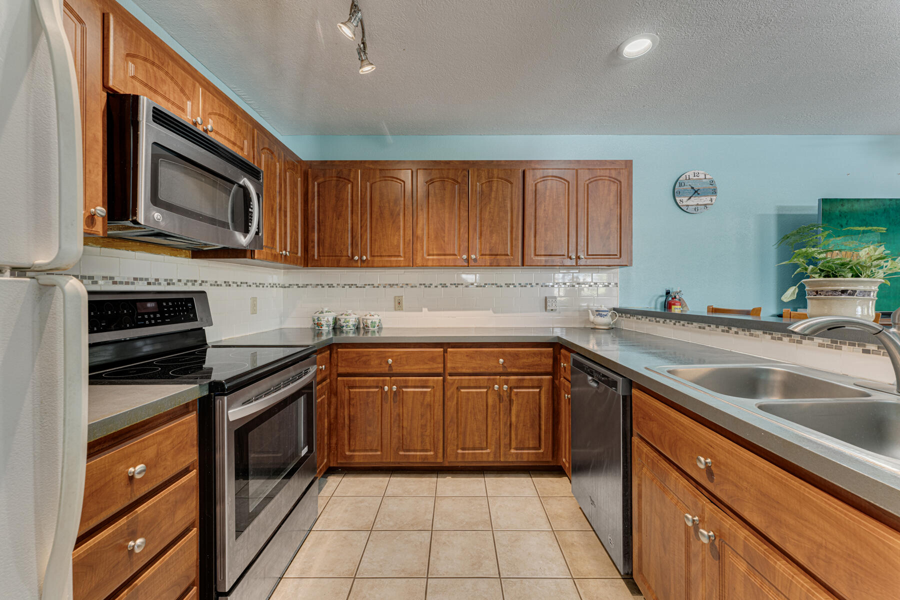 391 10th Street Key Colony Beach, FL 33051 - Photo 20 of 51 a kitchen with stainless steel appliances granite countertop a sink stove and microwave