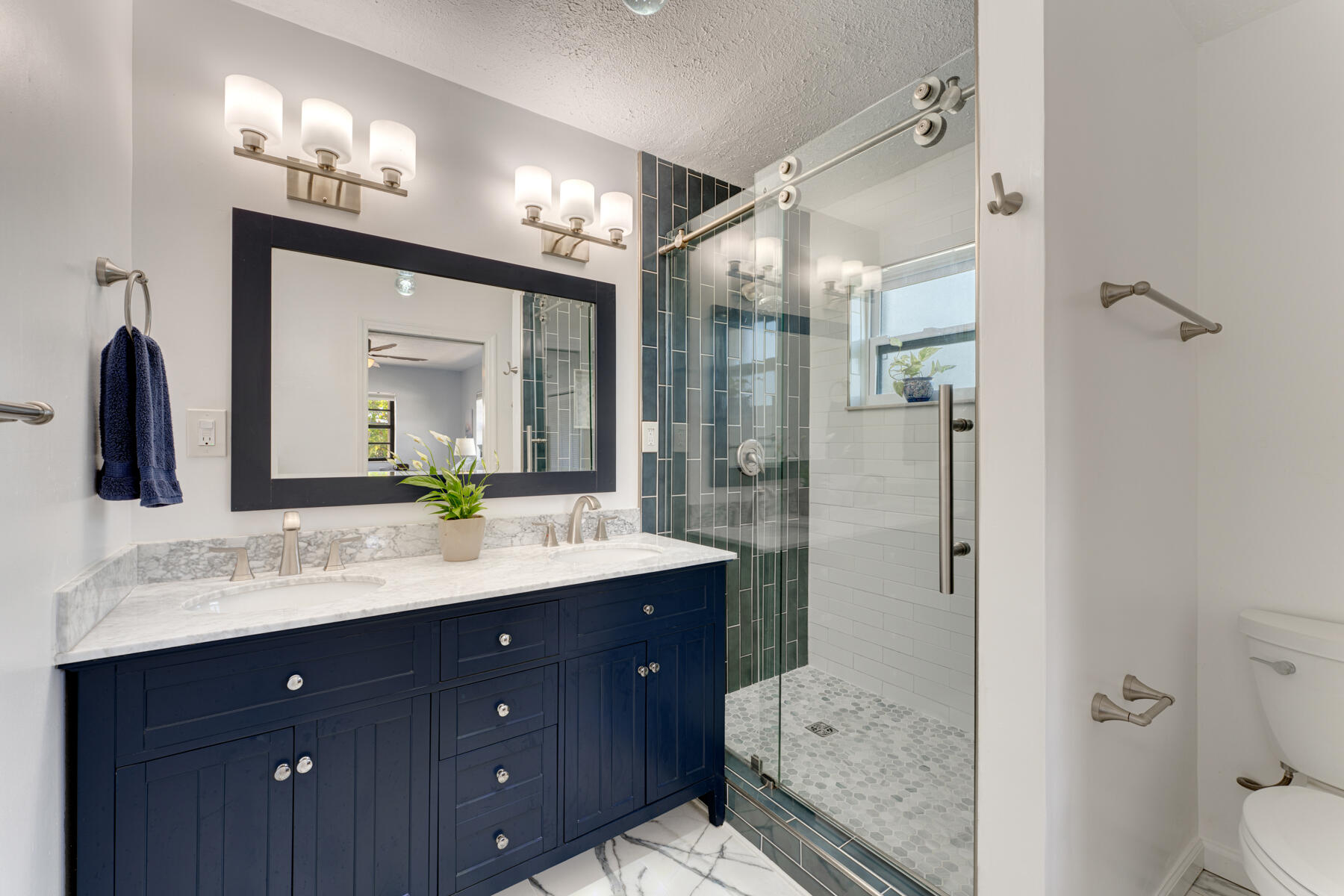 391 10th Street Key Colony Beach, FL 33051 - Photo 25 of 51 a bathroom with a granite countertop double vanity sink mirror and shower