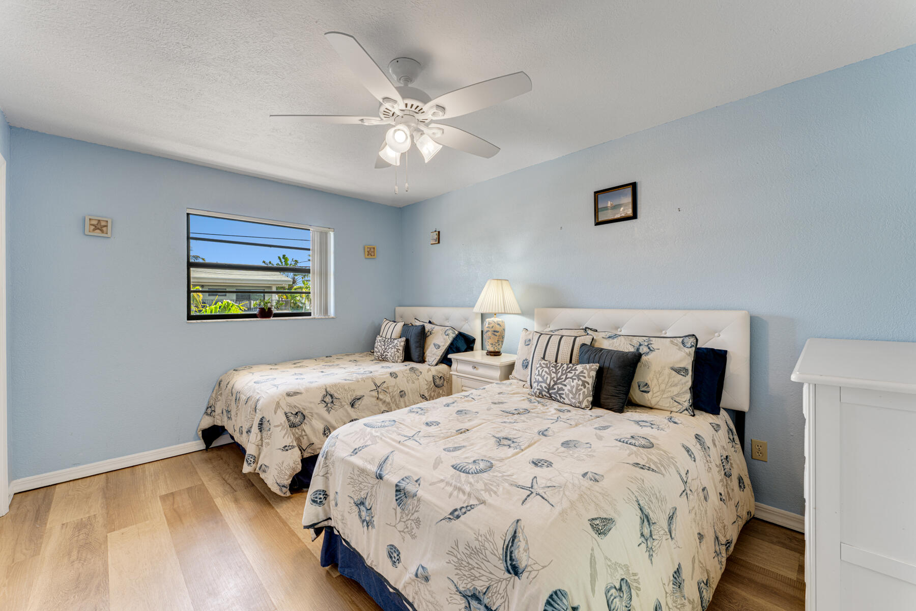391 10th Street Key Colony Beach, FL 33051 - Photo 27 of 51 a bedroom with two beds and a lamp