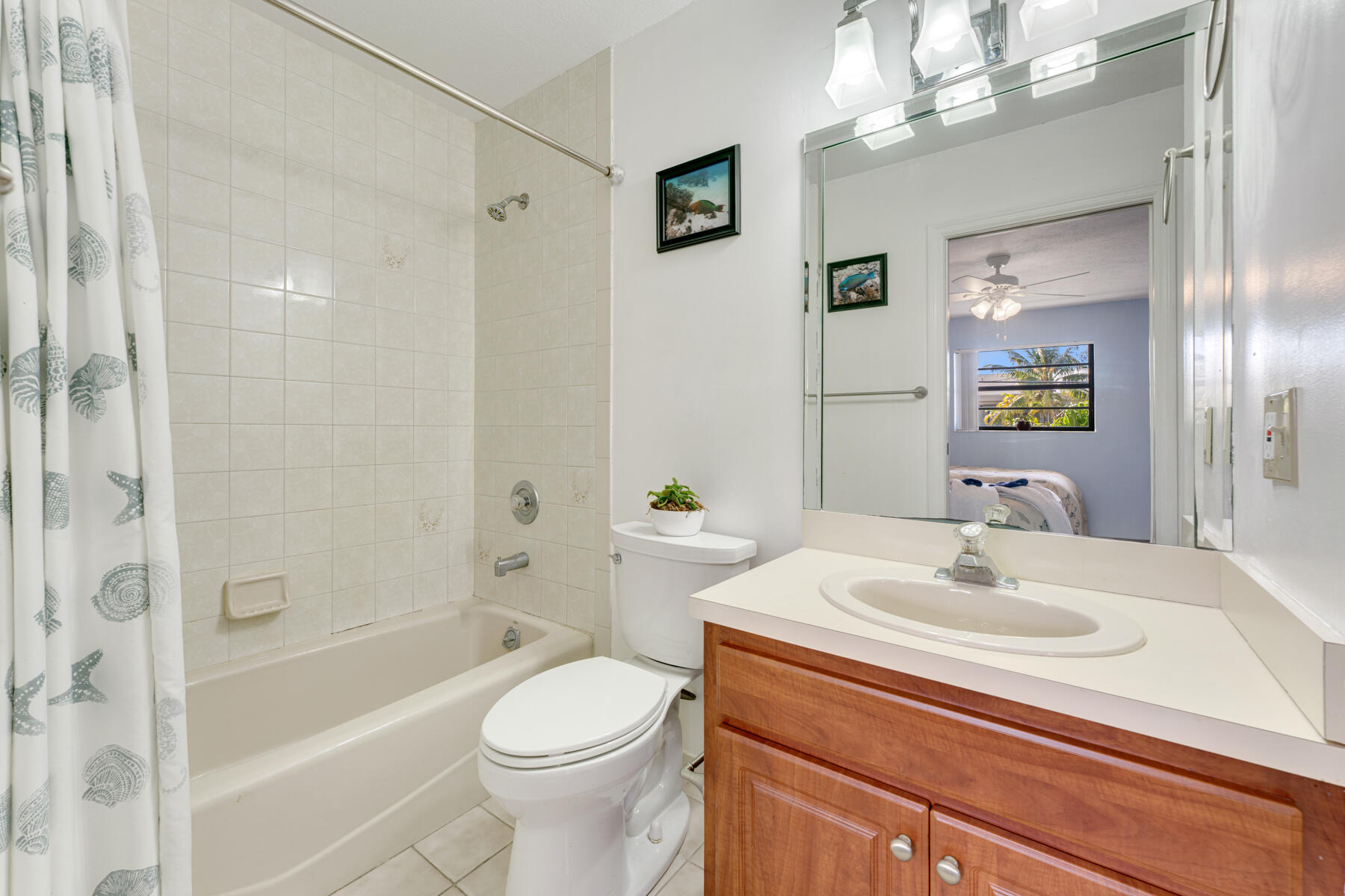391 10th Street Key Colony Beach, FL 33051 - Photo 29 of 51 a bathroom with a sink a toilet a mirror a bathtub and shower