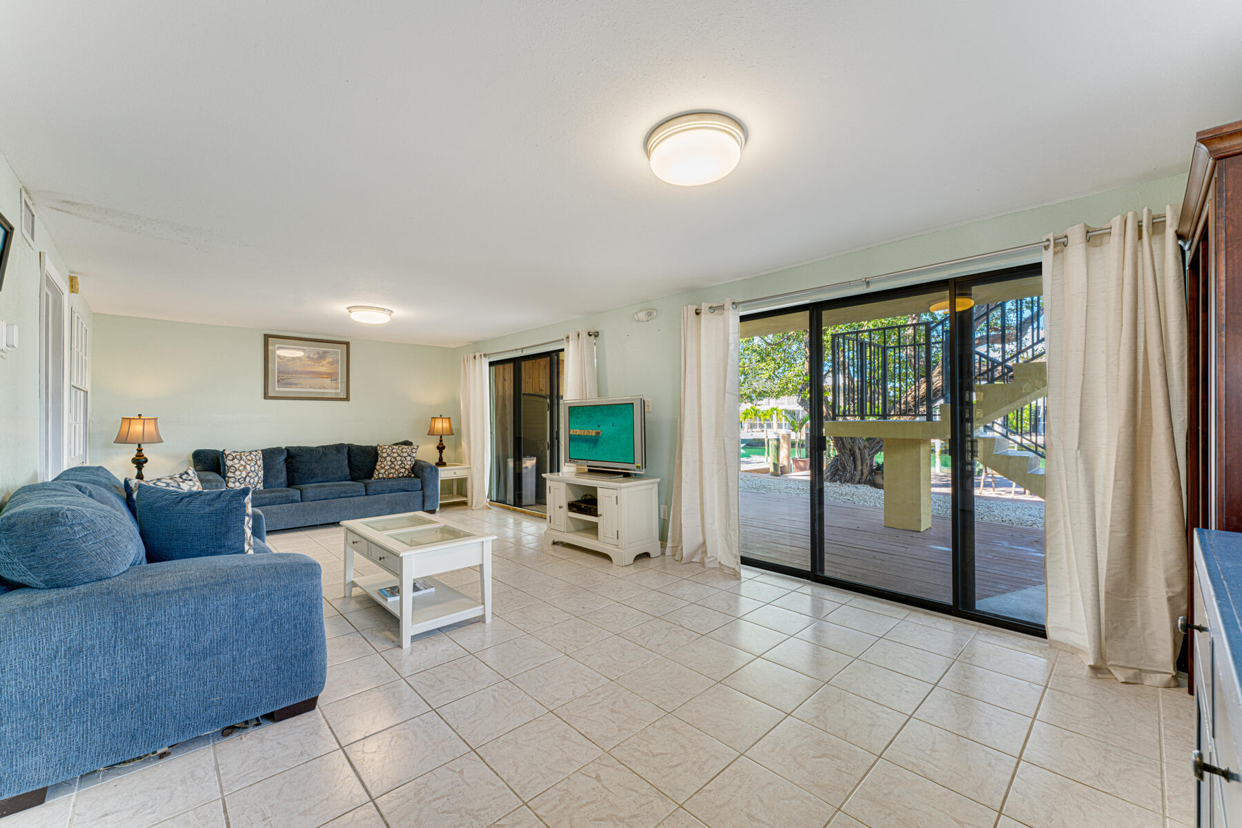 391 10th Street Key Colony Beach, FL 33051 - Photo 32 of 51 a living room with furniture and large windows