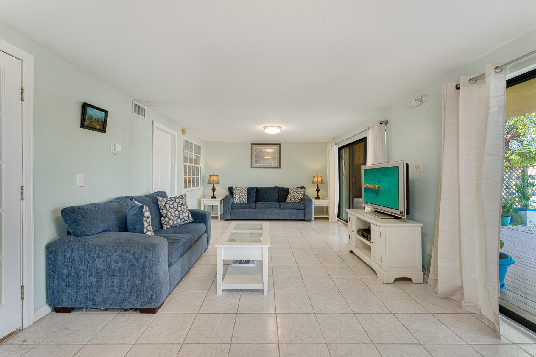 391 10th Street Key Colony Beach, FL 33051 - Photo 33 of 51 a living room with furniture and a flat screen tv
