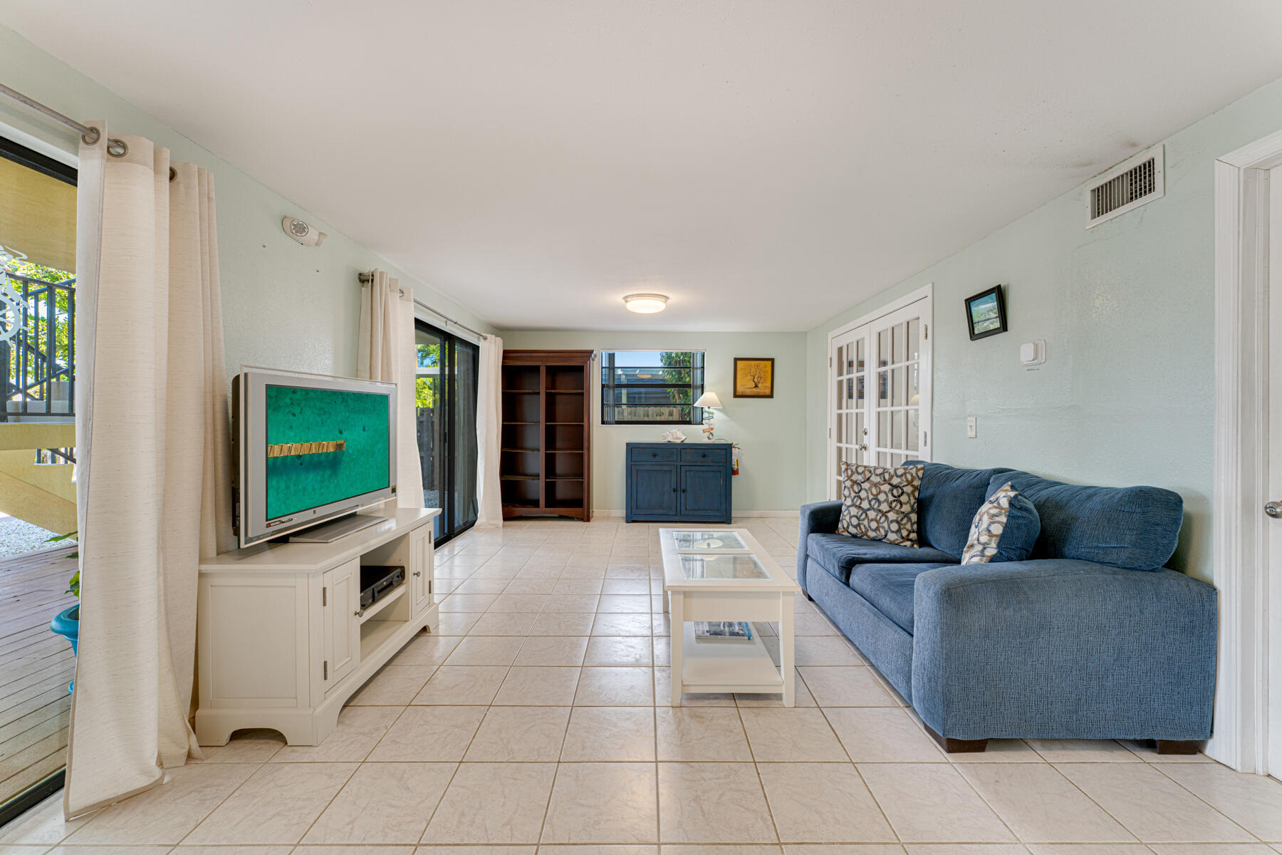 391 10th Street Key Colony Beach, FL 33051 - Photo 34 of 51 a living room with furniture and a flat screen tv