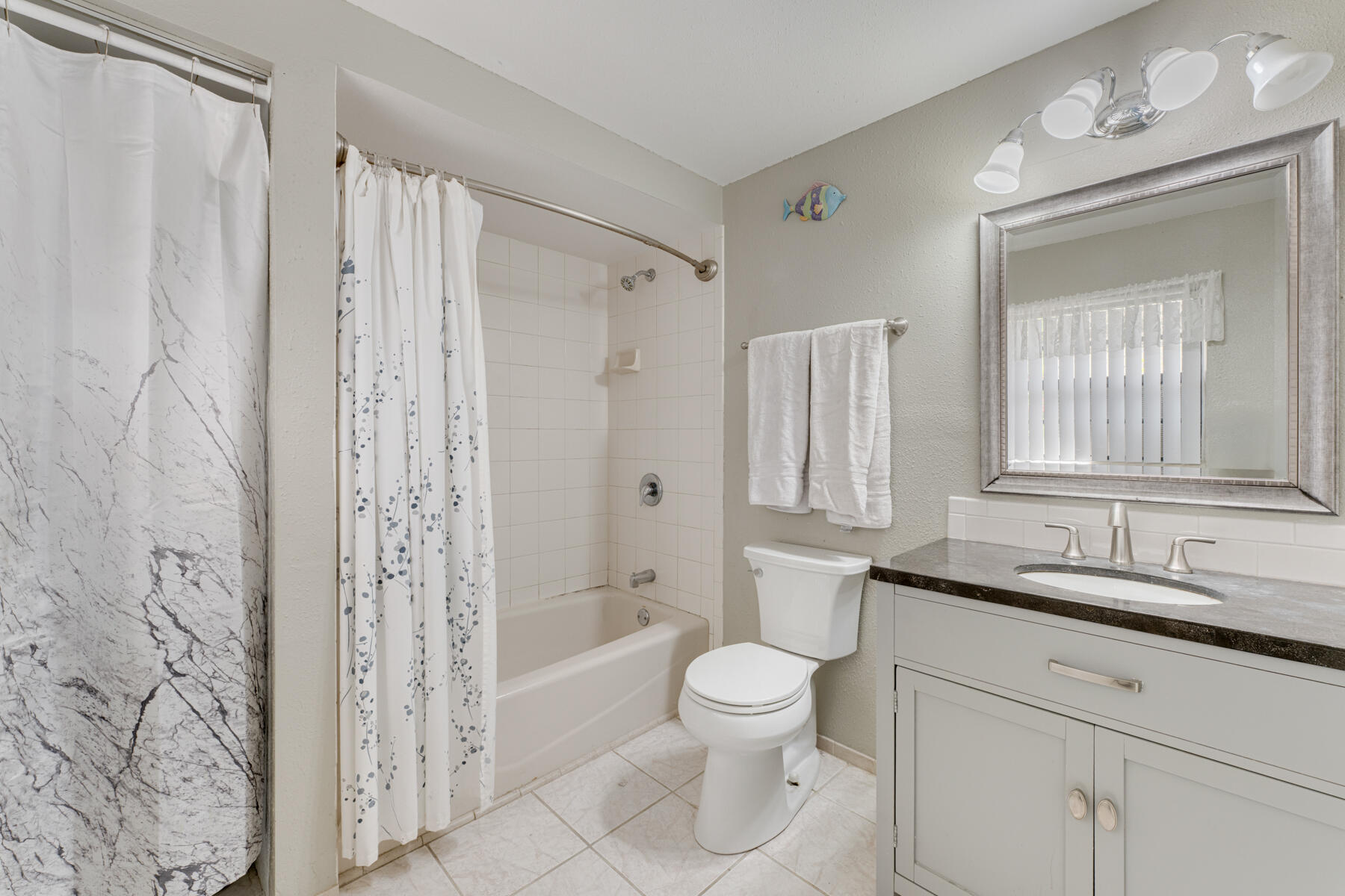 391 10th Street Key Colony Beach, FL 33051 - Photo 38 of 51 a bathroom with a double vanity sink toilet mirror and shower