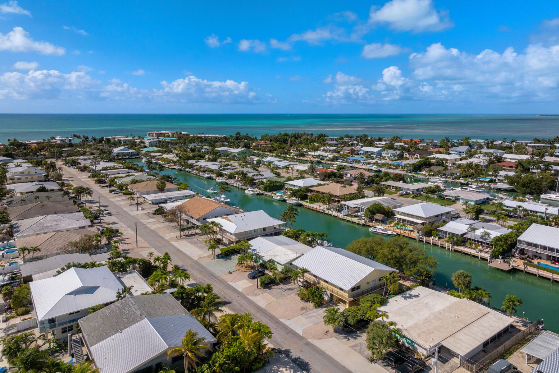 391 10th Street Key Colony Beach, FL 33051 - Photo 46 of 51 an aerial view of a city with lots of residential buildings and ocean view in back