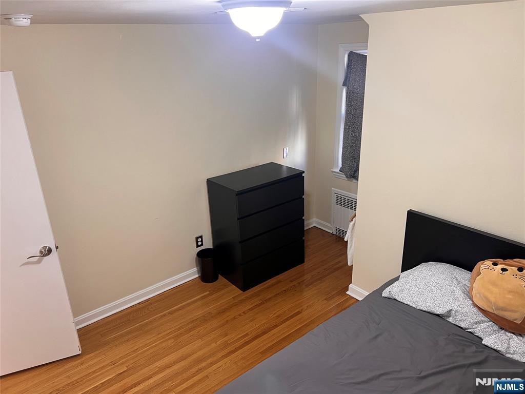 500 Weart Avenue, Unit 2 Lyndhurst, NJ 07071 - Photo 18 of 20 a bedroom with a bed and wooden floor