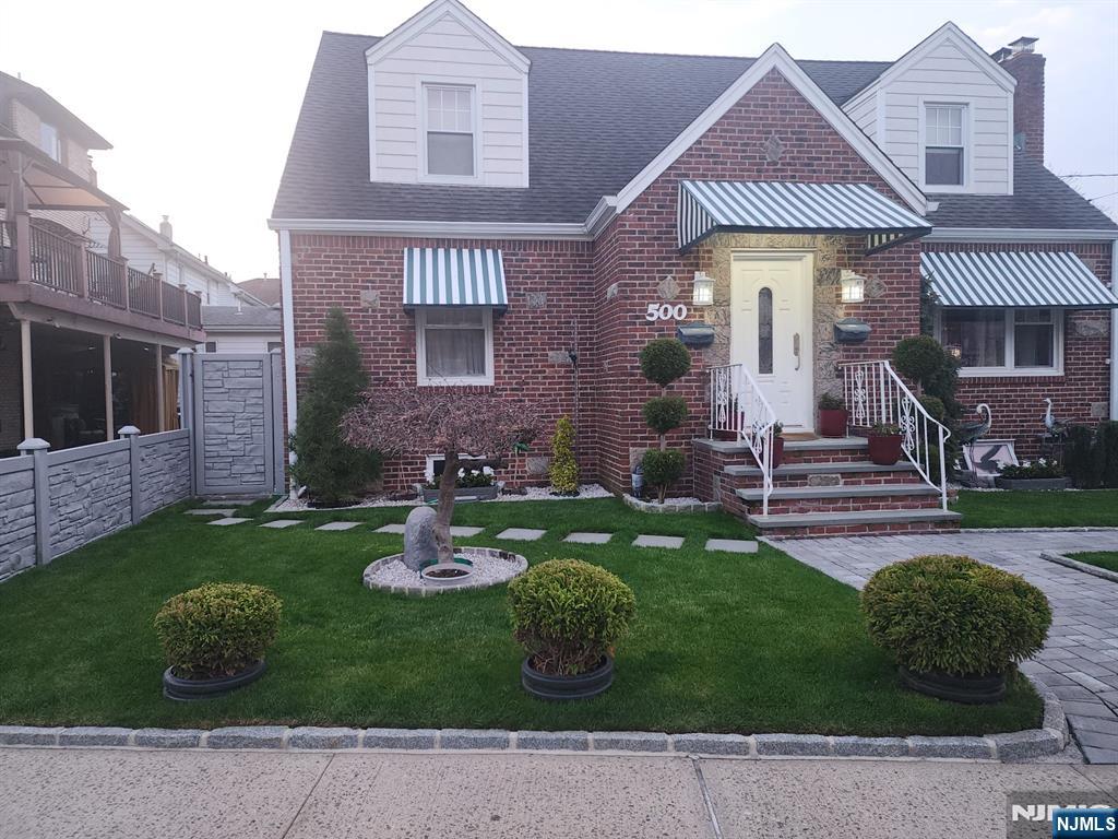 500 Weart Avenue, Unit 2 Lyndhurst, NJ 07071 - Photo 2 of 20 a front view of a house with garden