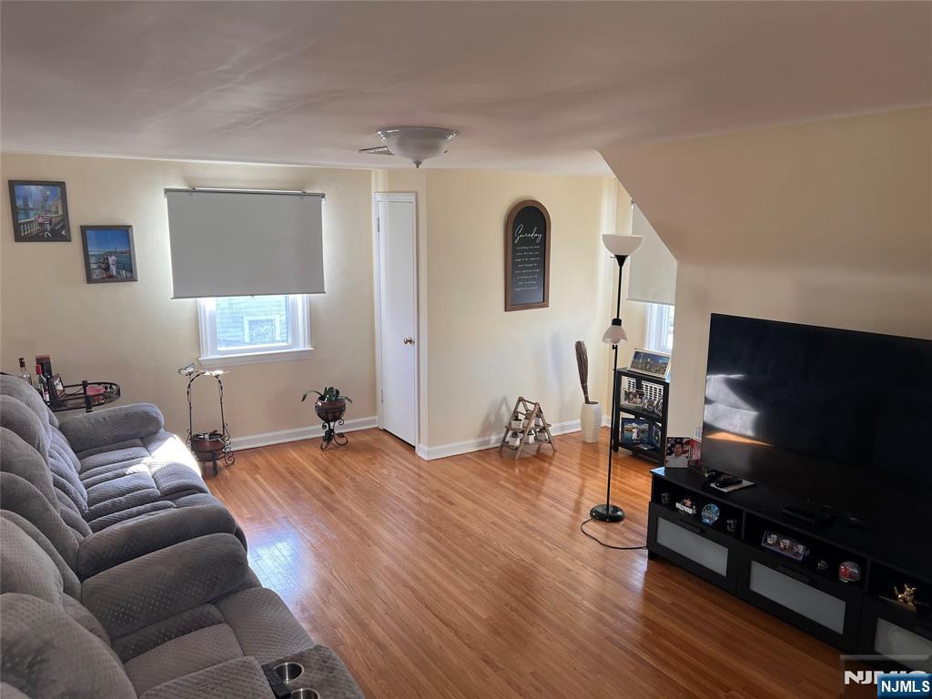 500 Weart Avenue, Unit 2 Lyndhurst, NJ 07071 - Photo 3 of 20 a bedroom with furniture and a flat screen tv