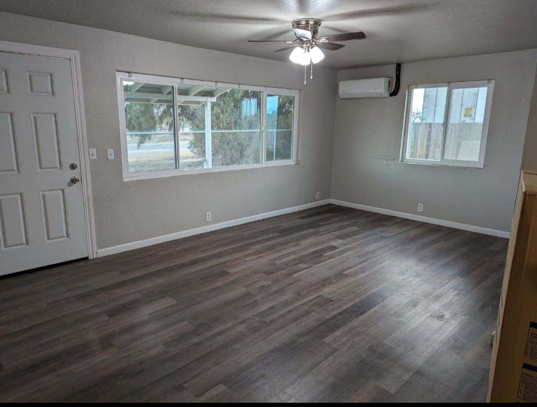 16896 Road 400 Madera, CA 93636 - Photo 2 of 6 a view of an empty room with wooden floor and a window