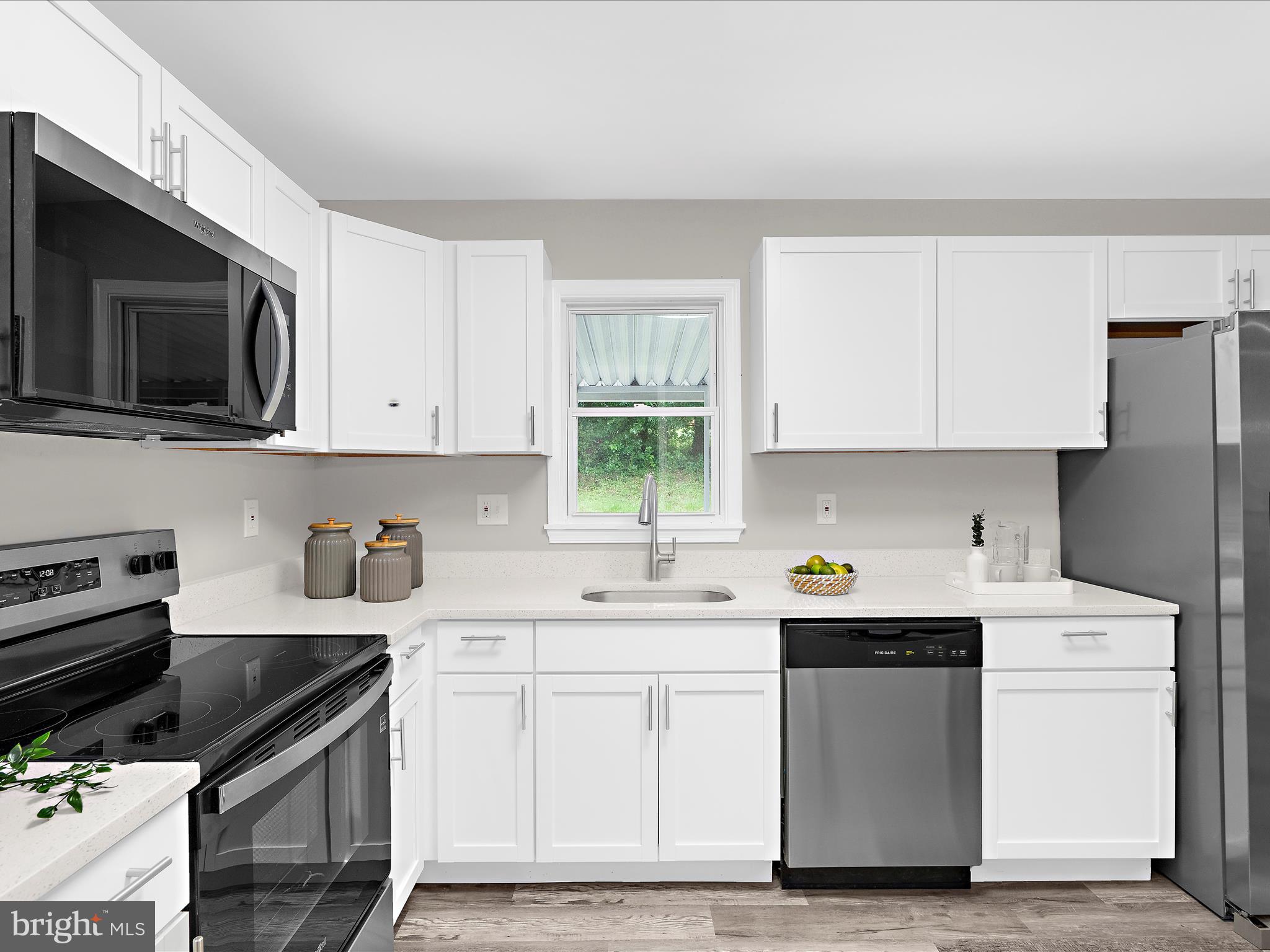 813 Ferguson Road Joppa, MD 21085 - Photo 16 of 39 a kitchen with a sink stove and microwave