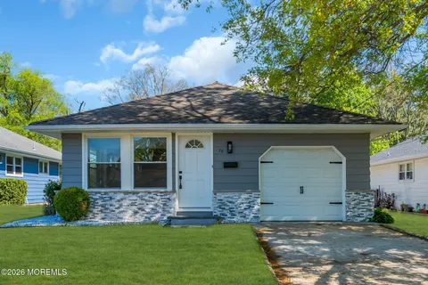 a front view of a house with a garden and yard