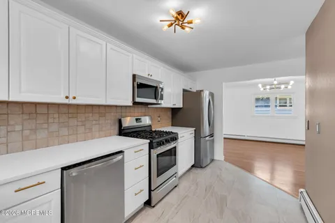 a kitchen with stainless steel appliances a stove microwave and a refrigerator