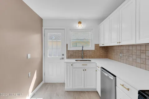 a kitchen with a sink cabinets and window